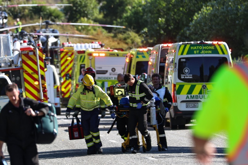 Emergency workers carry a stretcher at the crash site near the Devil's Staircase today. Photo:...