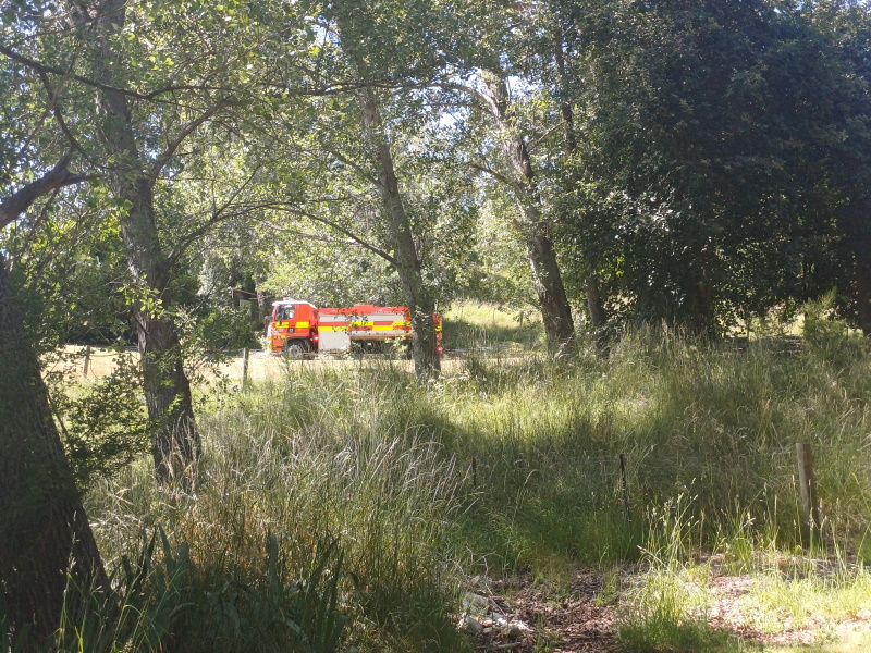 A fire engine responds to the blaze, up a long driveway from the road, near Queenstown today....