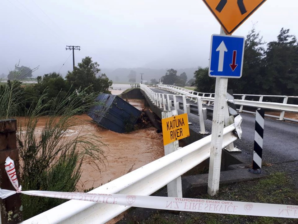 Debris is carried down a river in the small community of Bainham in Golden Bay. Photo: Reuters