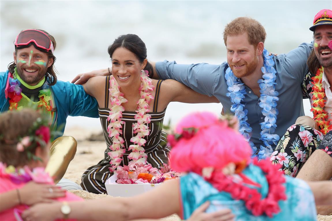 Prince Harry and Meghan Markle take part in a group hug with members of OneWave, an awareness...