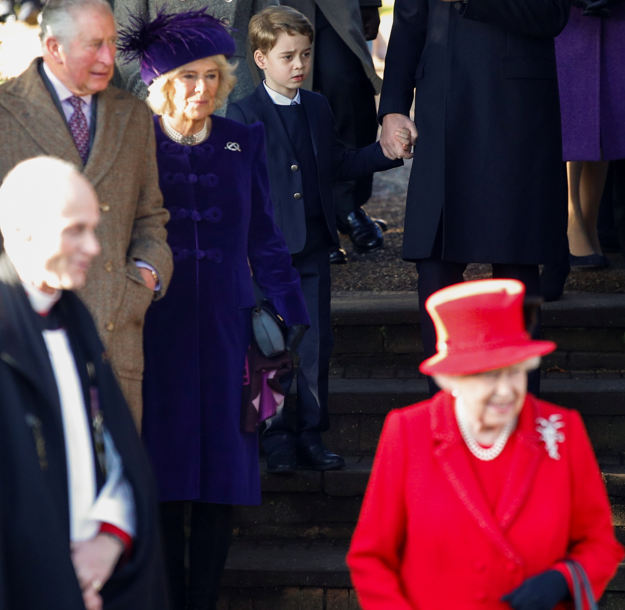 The Queen (front) leaves St Mary Magdalene's church after the Christmas Day service on her...