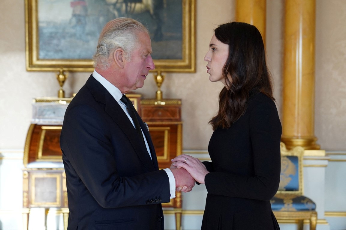 King Charles III speaks with New Zealand Prime Minister Jacinda Ardern at Buckingham Palace in...