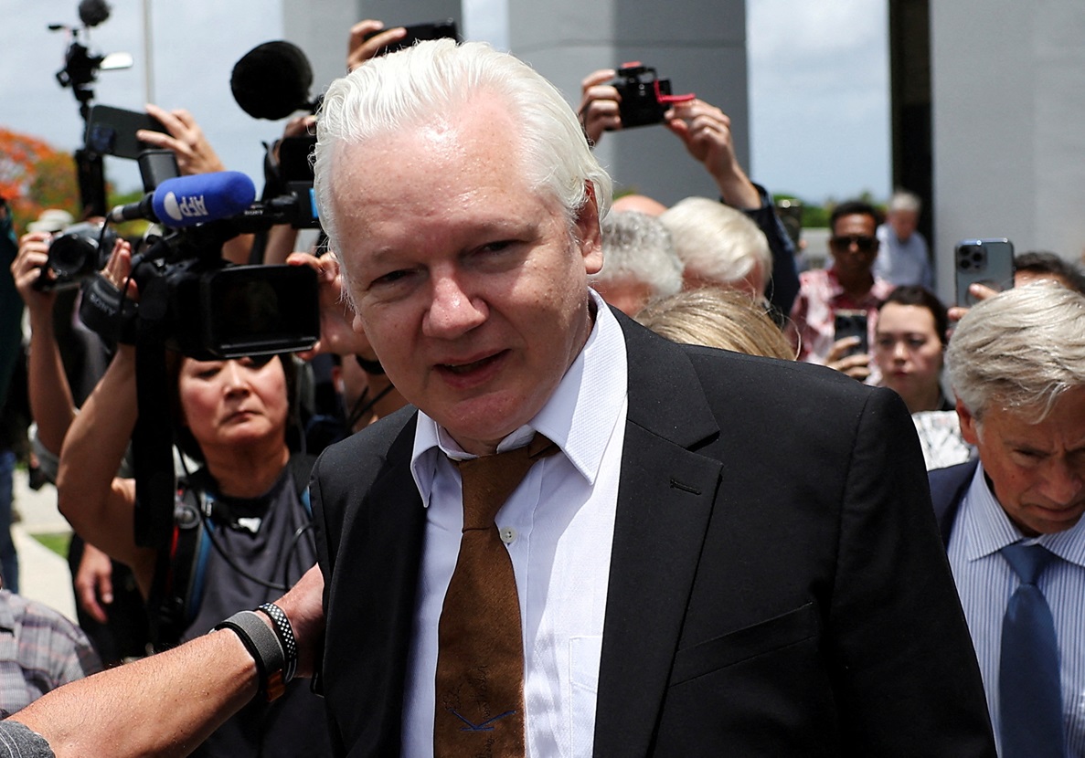 Julian Assange walks outside the courthouse following the hearing in Saipan, Northern Mariana...