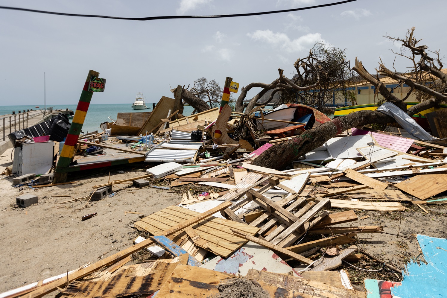 Scattered debris clutters the waterfront after Hurricane Beryl passed the island of Carriacou,...