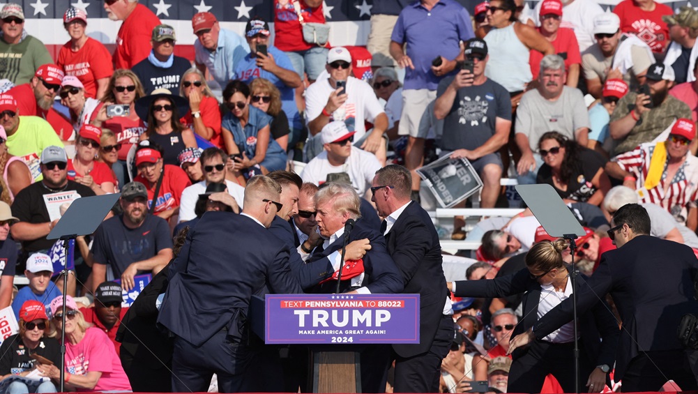 Donald Trump is assisted by Secret Service personnel after he was shot in the ear during a...