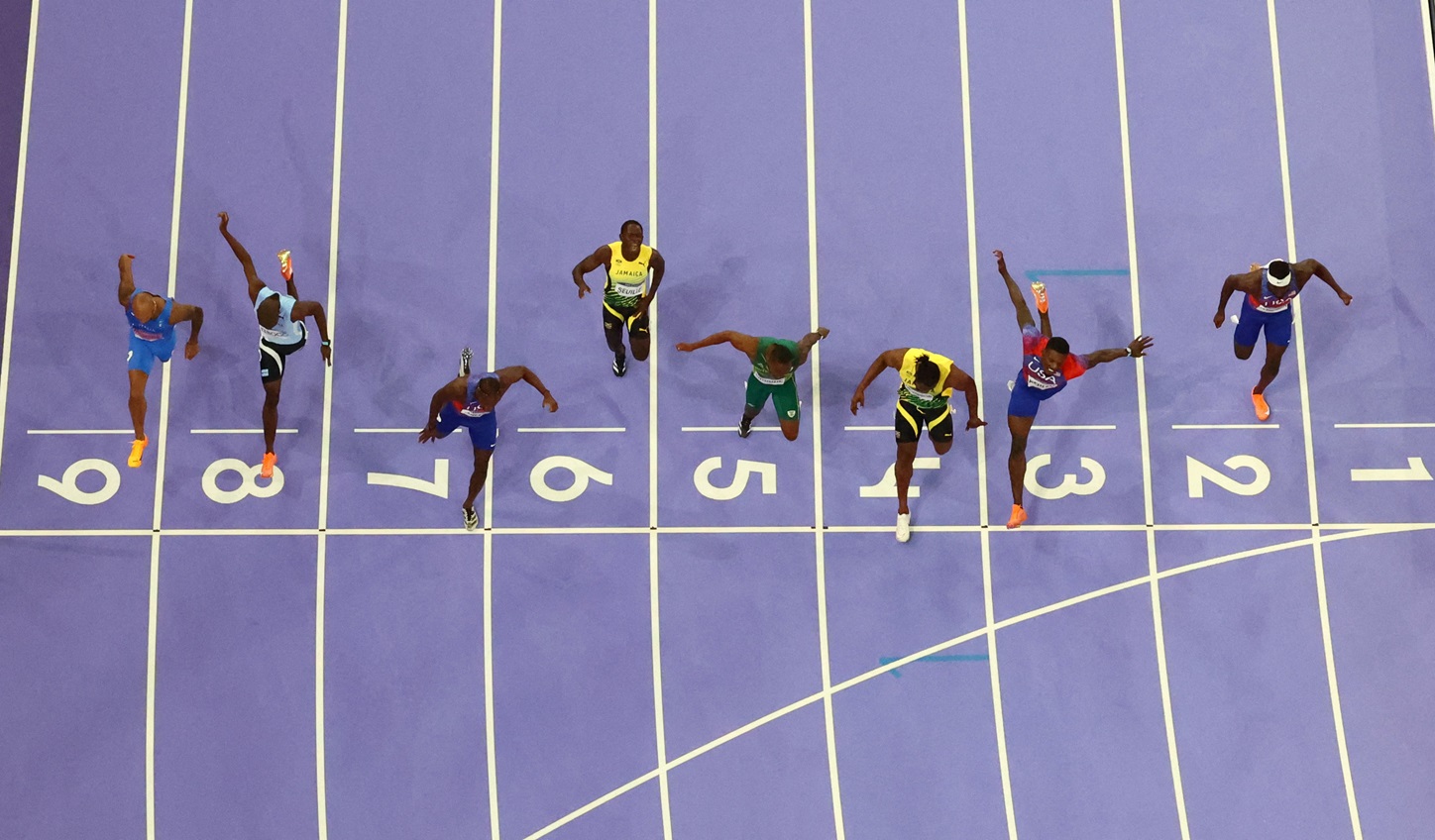 Noah Lyles (7) crosses the line to win gold ahead of second-placed Kishane Thompson (4) and third...