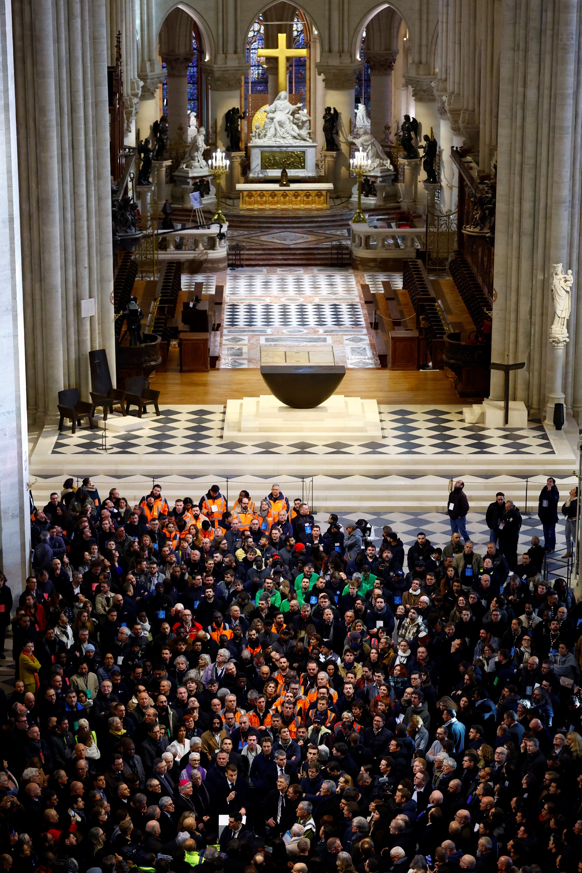 President Emmanuel Macron praised the restoration work at a gathering that included carpenters,...