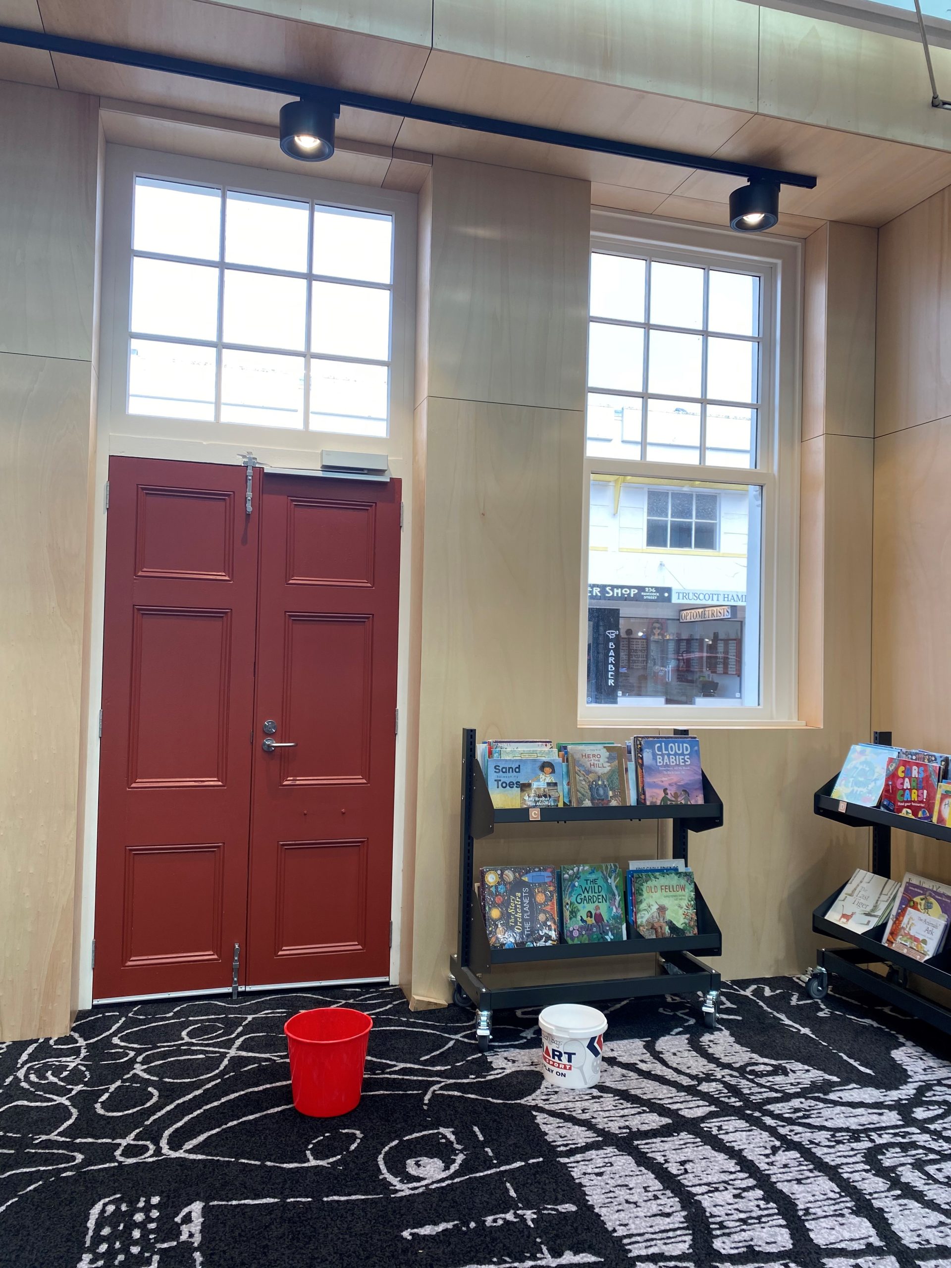 Two buckets in the children's library to catch the drips from a leaky glass panel. PHOTO:...