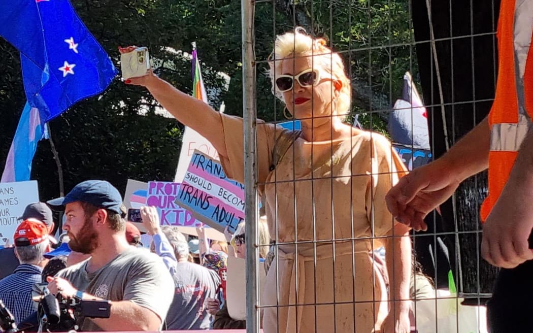 Posie Parker films the crowd at Albert Park. Photo: RNZ