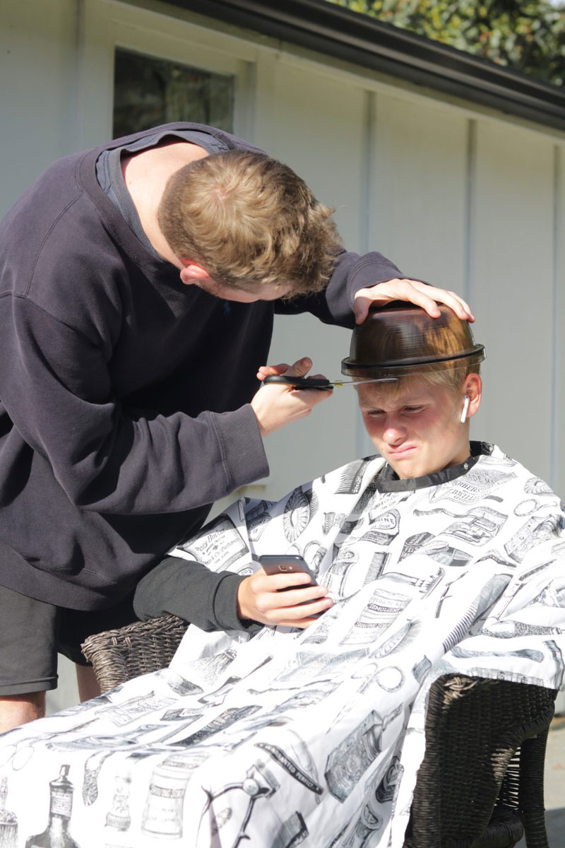 Ben Sapsford cuts his brother Josh's hair.