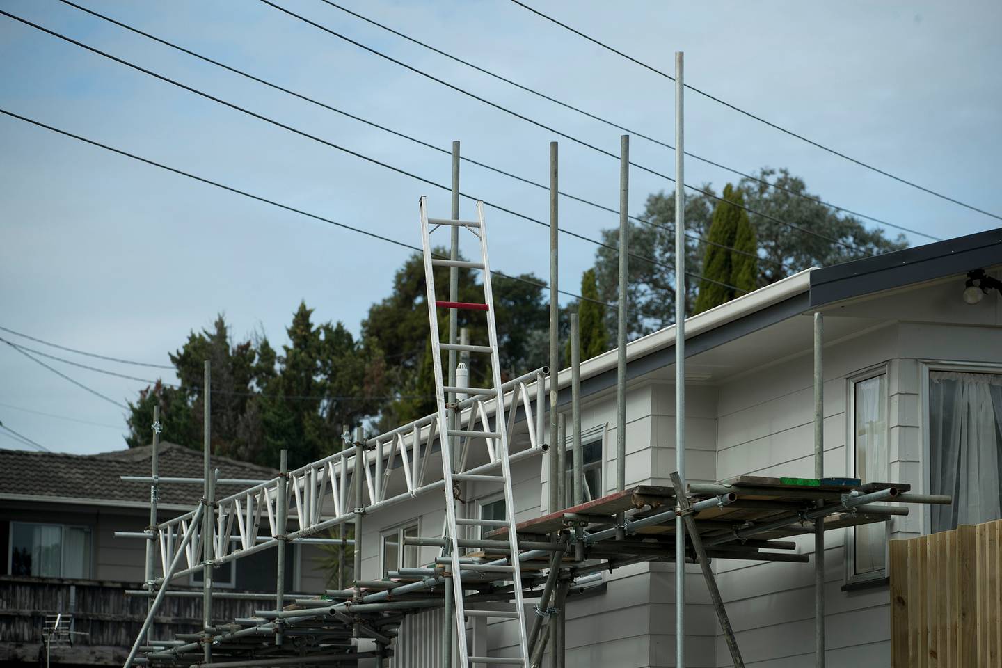 Scaffolding sits beneath overhead powerlines at the house in Massey where a scaffolder was...