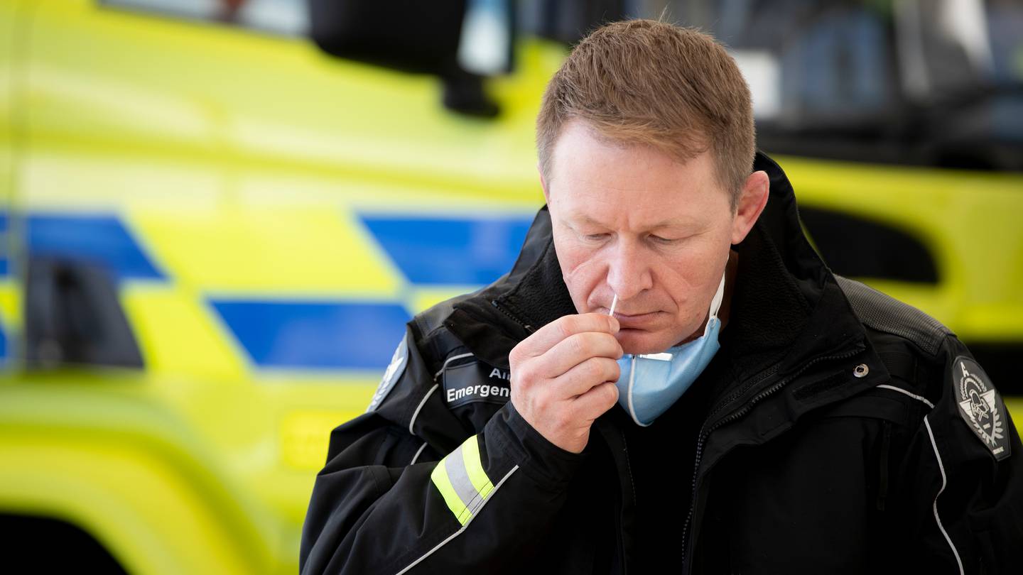 Auckland Airport chief emergency services officer Neil Swailes uses a Covid-19 rapid antigen...