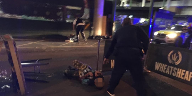 The alleged terrorists can be seen in in this photo after being shot by police. Photo: Gabriele...