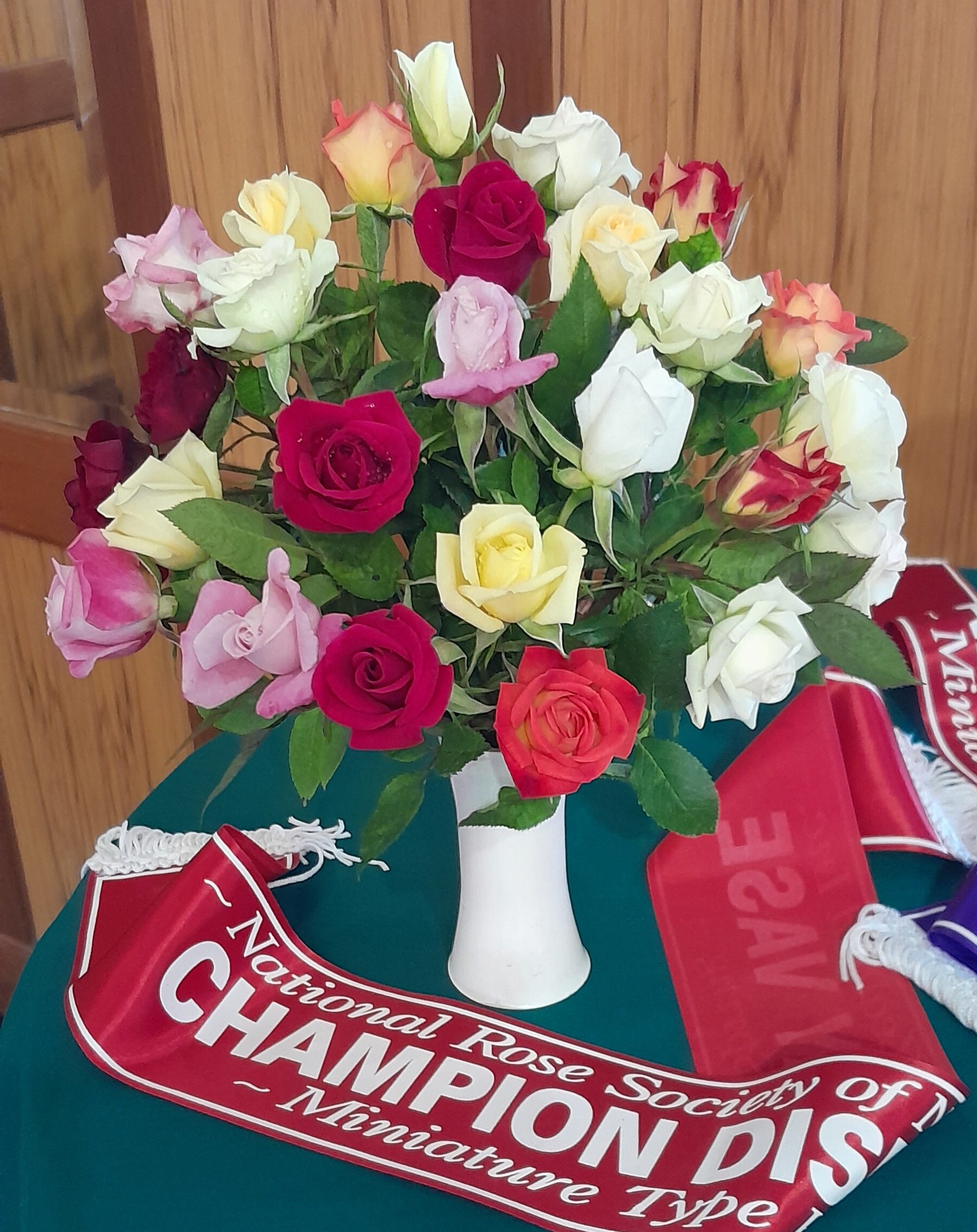 Sheree Gare, of Waikato Rose Society, won the champion miniature display vase trophy for this...