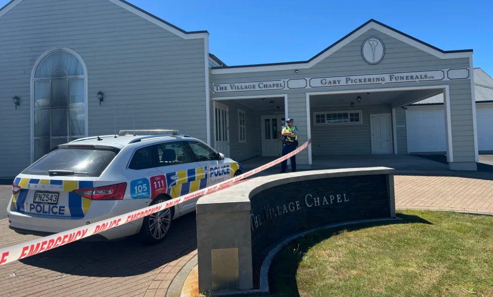 A police officer guards the Gary Pickering Funeral Home in Walton's Ave. Photo: RNZ 