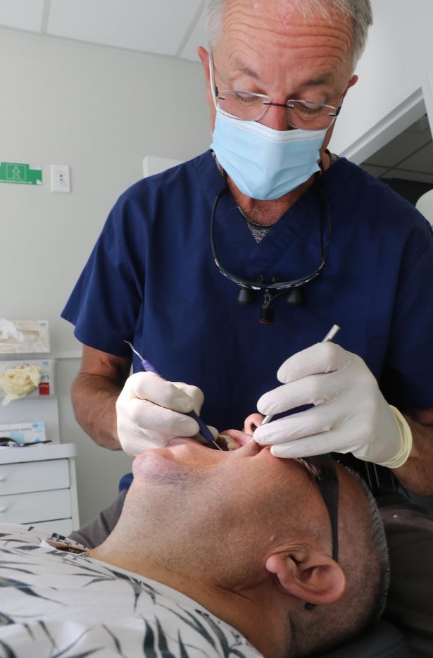 Christchurch dentists like David Walsh, seen here filling a cavity for Emilios Kotzikas, have...