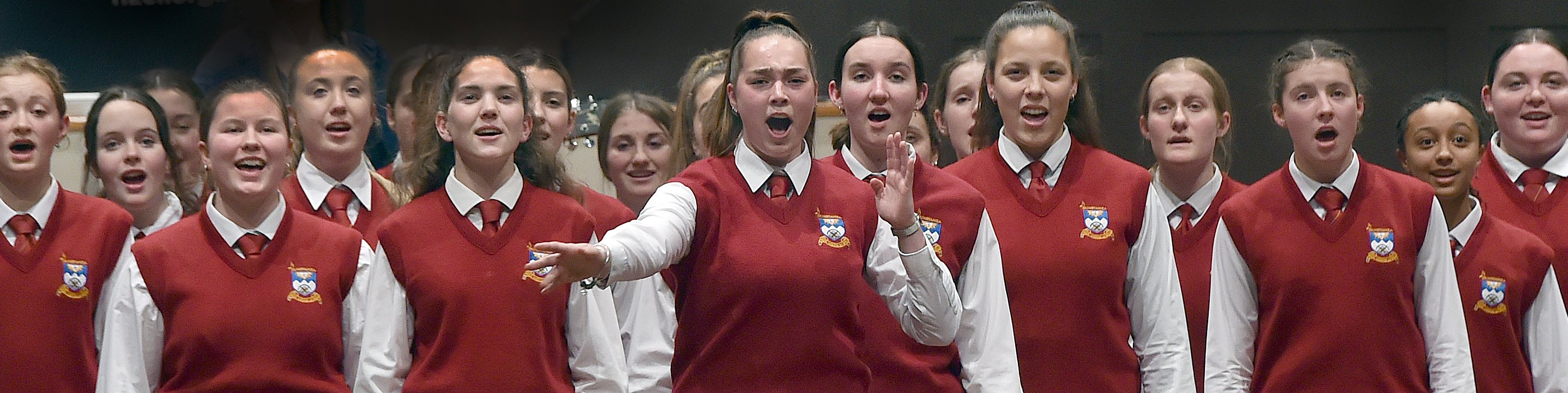 Aja Tate-Bell (17) leads the Dunstan High School choir at the Big Sing 2021 regional competition...