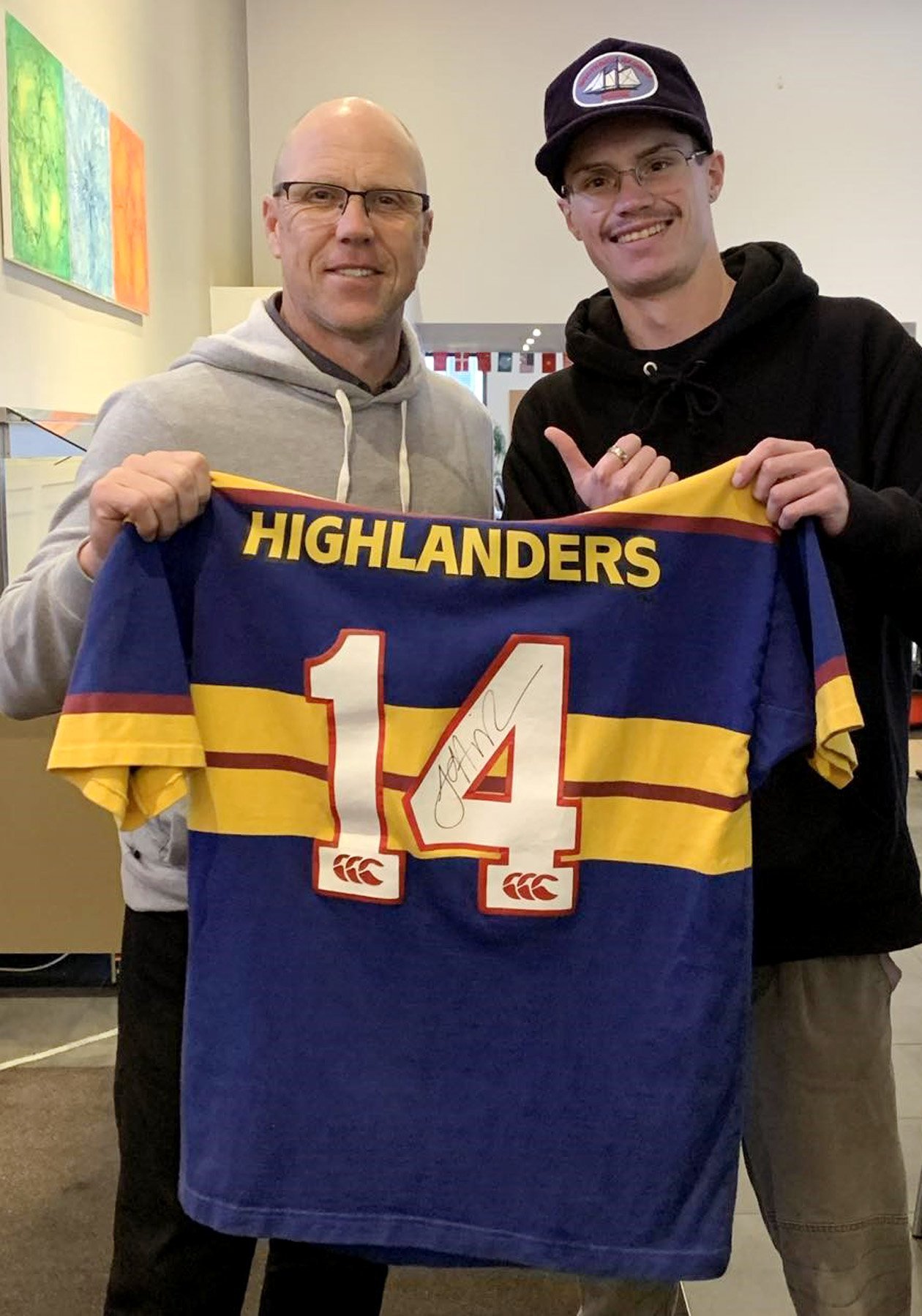 Otago rugby great and former All Black Jeff Wilson (left) gives his signed Highlanders jersey to...