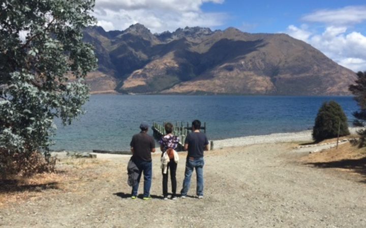 Tyler Nii’s parents and brother looking out over Lake Wakatipu. Photo: NZ Police