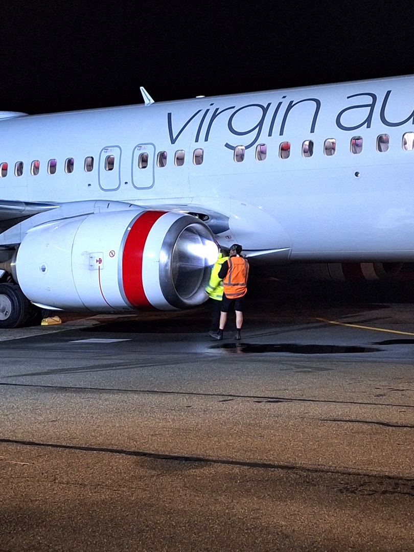 An inspection is made of the aircraft's damaged engine. Photo: Toni McDonald