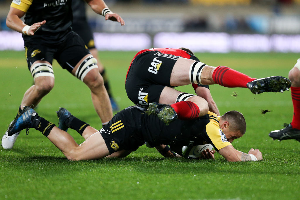 TJ Perenara of the Hurricanes is tackled by Matt Todd of the Crusaders. Photo: Getty