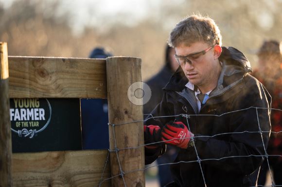 George Dodson taking part in a fencing challenge on his way to winning the Young Farmer of the...