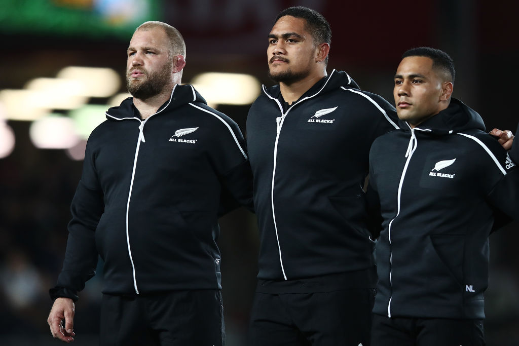 Owen Franks (L) and Ngani Laumape flank Ofa Tu'ungafasi before the match between the All Blacks...