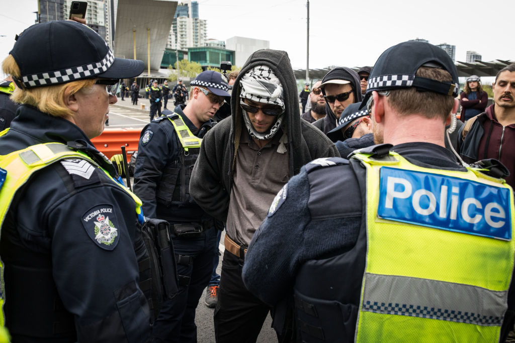 Police perform a bag search on an attendee during the protest on Friday. Photo: Getty Images