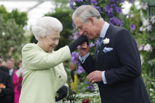 Queen Elizabeth II presents Prince Charles with the Royal Horticultural Society's Victoria Medal...