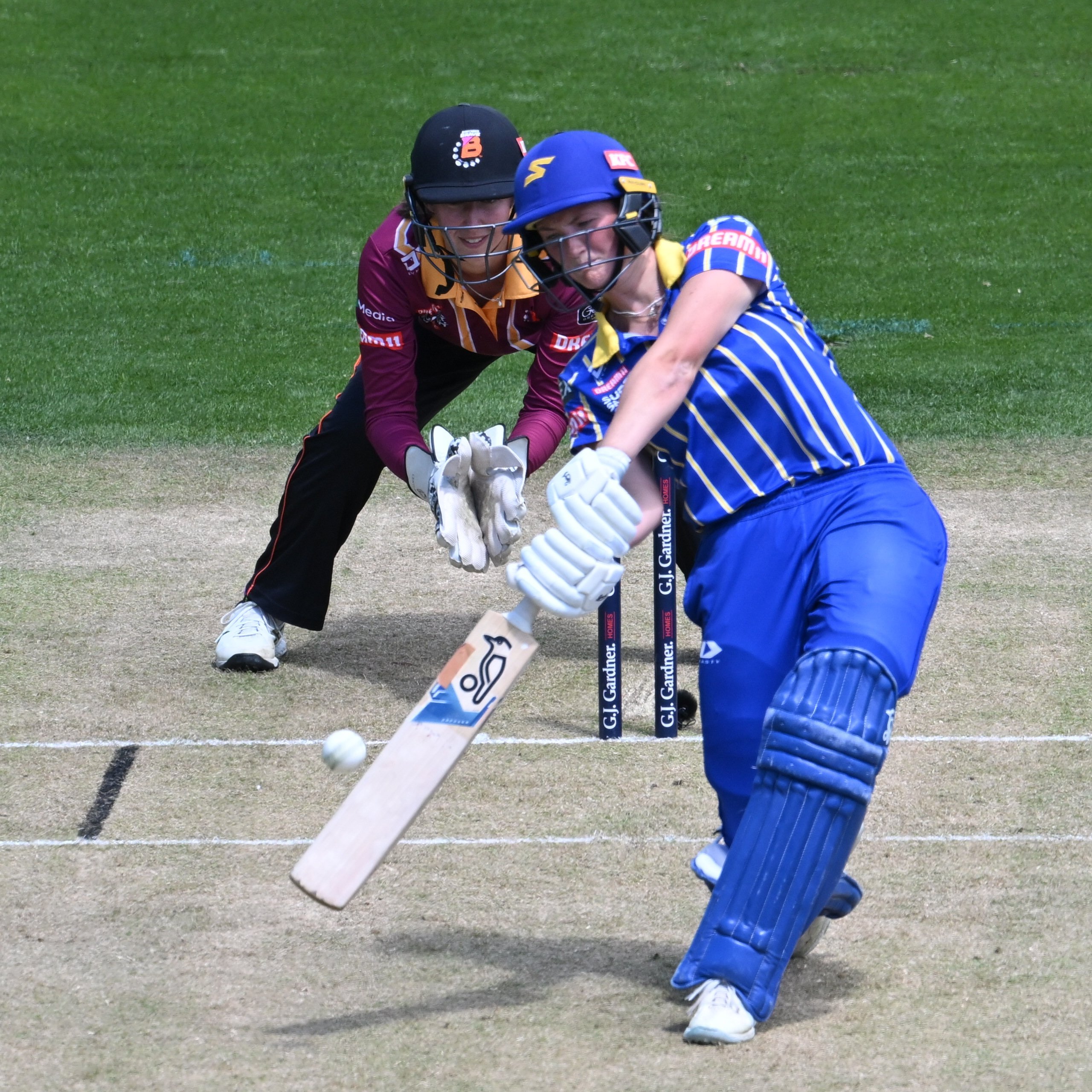 Otago Sparks batter Olivia Gain launches into a shot in front of Northern Brave wicketkeeper...