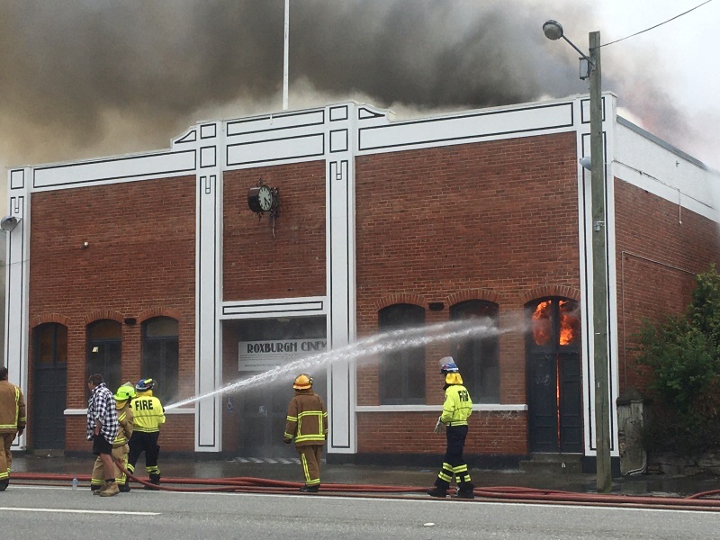 Firefighters battle the blaze at the cinema building. Photo: ODT