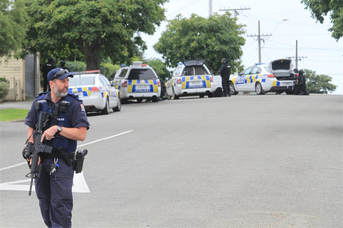 Armed police surround a Hull St address this morning. Photo: Hamish MacLean