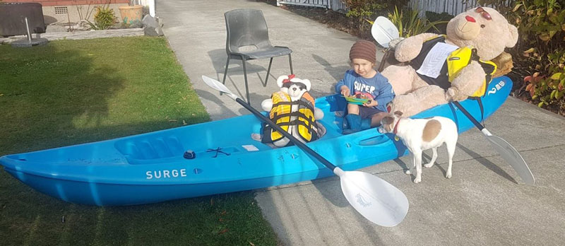 Finn Toth-McDonald poses with a teddy bear version of Olympic flatwater canoeist Lisa Carrington....