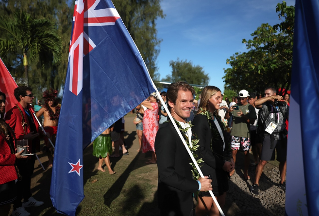 Billy Stairmand carries the New Zealand flag at the opening ceremony in Tahiti, where Olympic...