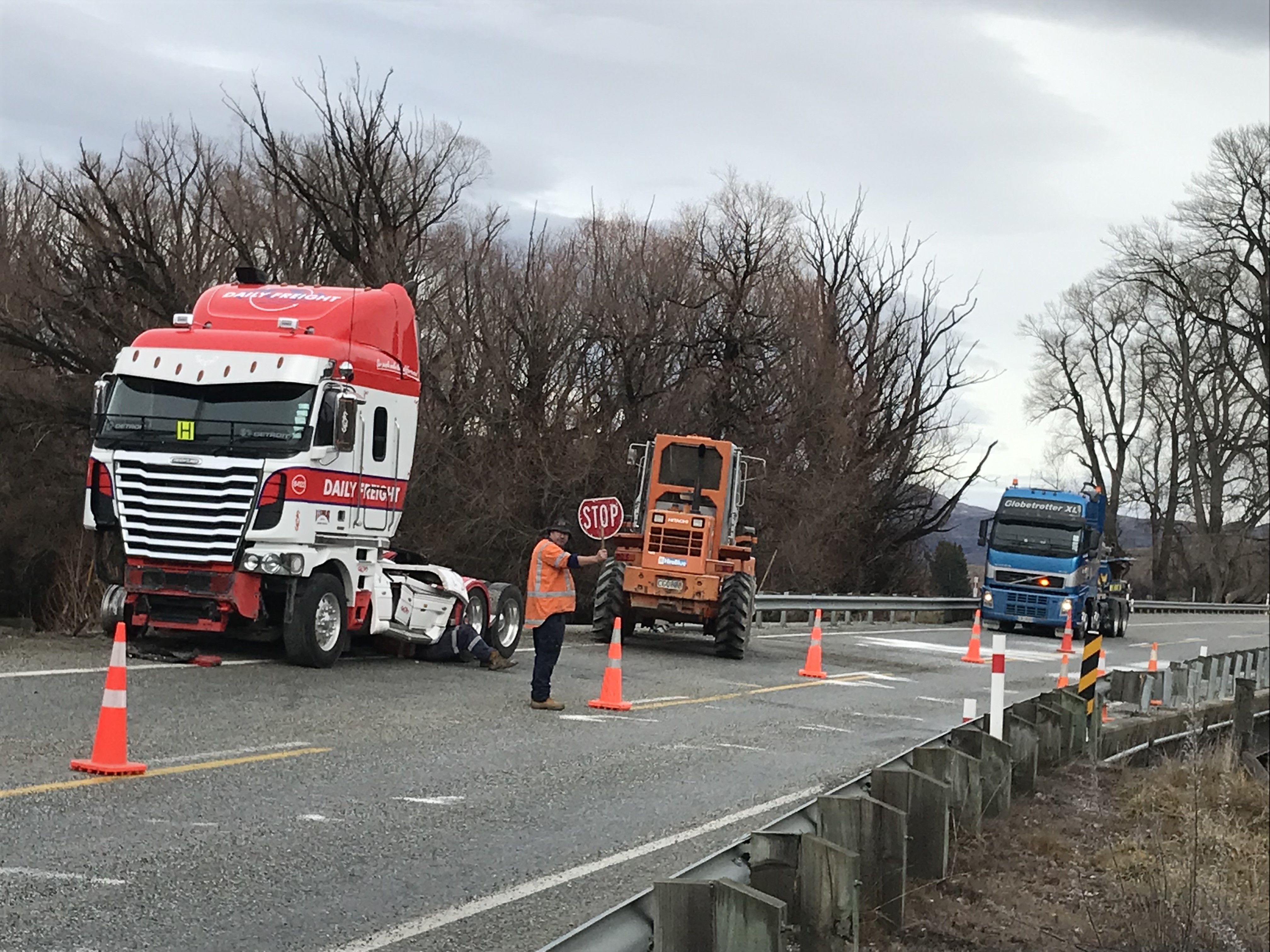 Contractors work to secure a truck unit involved in a crash on the two-lane Morven Hill Bridge...