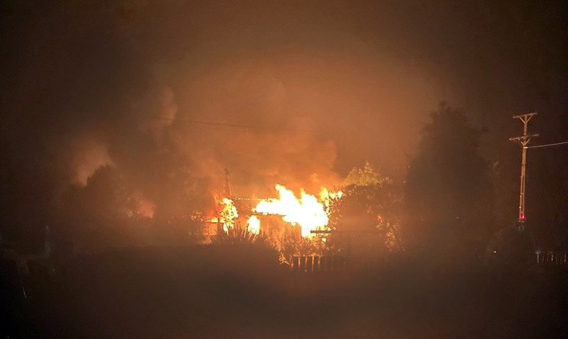 Flames engulf a View St house, in Manapouri, early yesterday. PHOTO: MIKE MOLINEUX