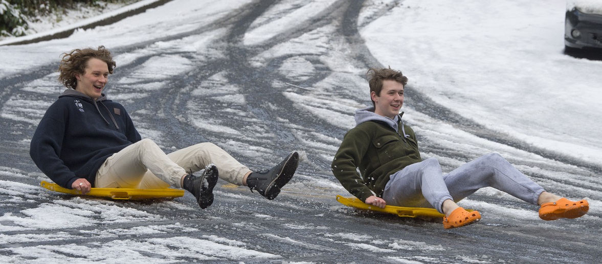 University of Otago Students Leo and Zac (left) Holt slide down Regent St in Dunedin on recycling...