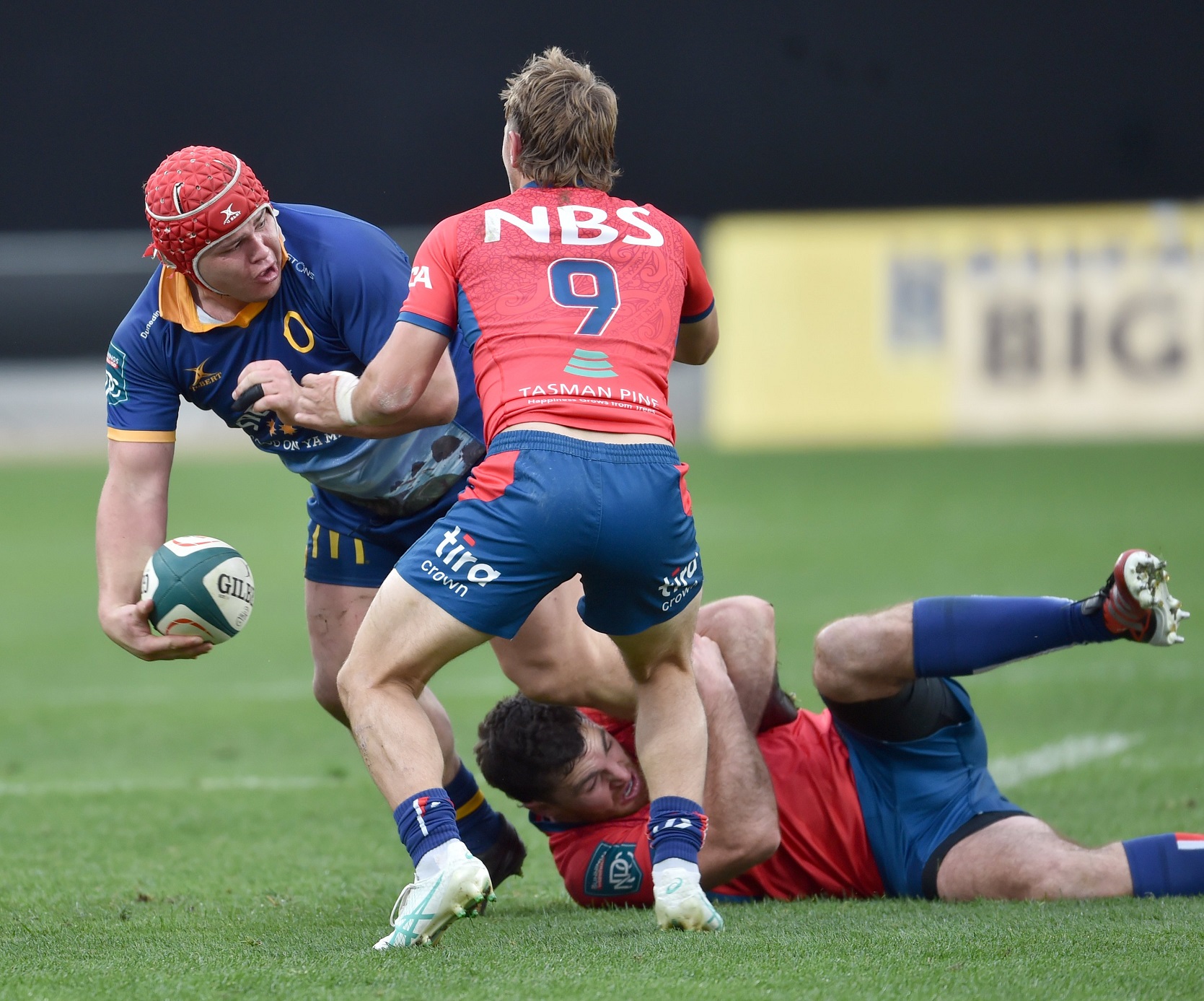 Otago prop Benjamin Lopas is watched by Tasman halfback Louie Chapman.