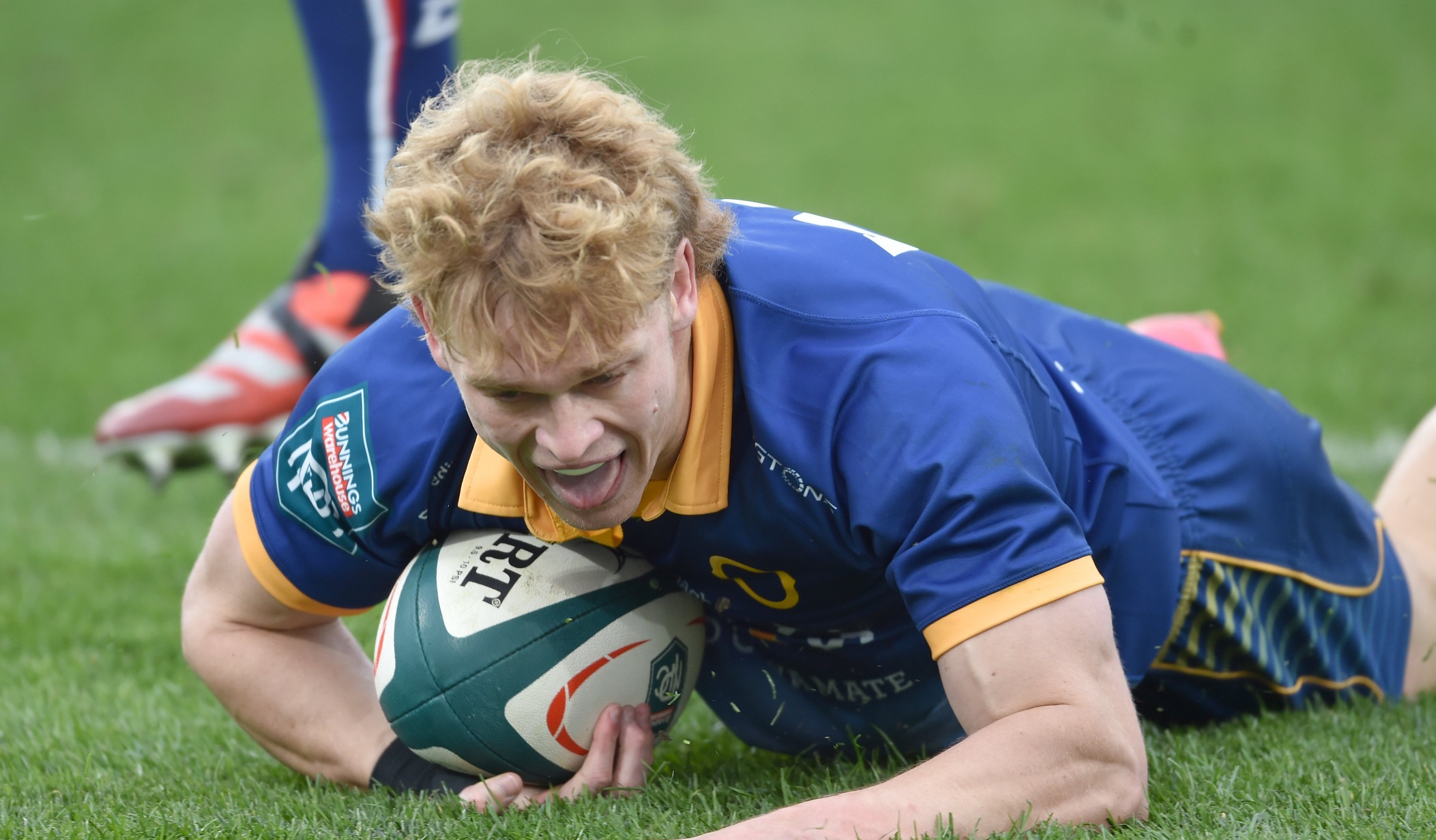 Otago fullback Finn Hurley celebrates his try.