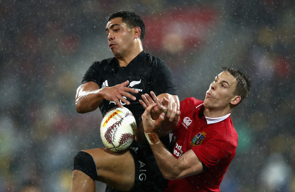 Liam Williams of the Lions and Anton Lienert-Brown of the All Blacks scramble for the ball. Photo...