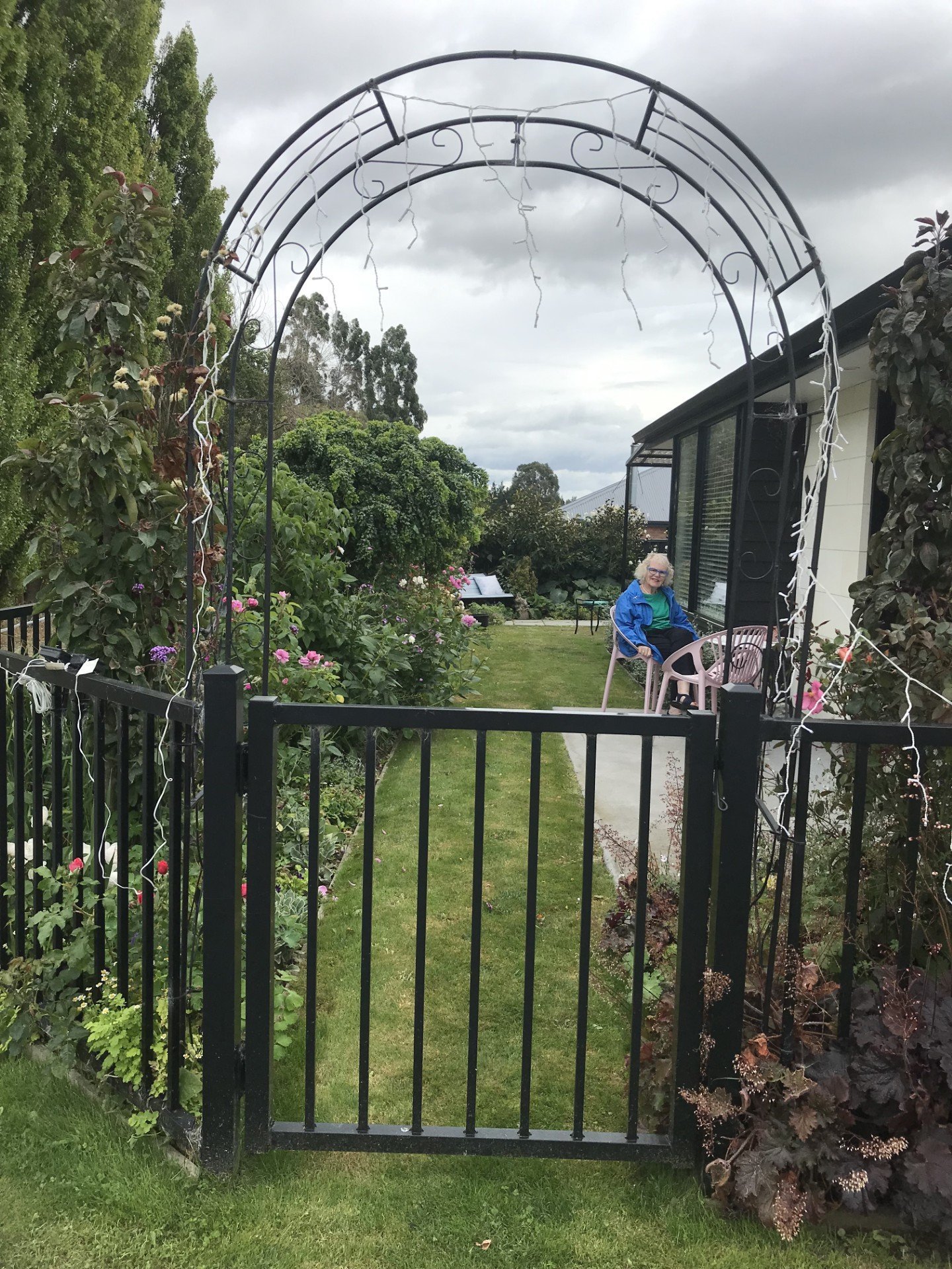 A welcoming archway which frames Sherryn Bryan sitting in her garden. PHOTOS: GILLIAN VINE