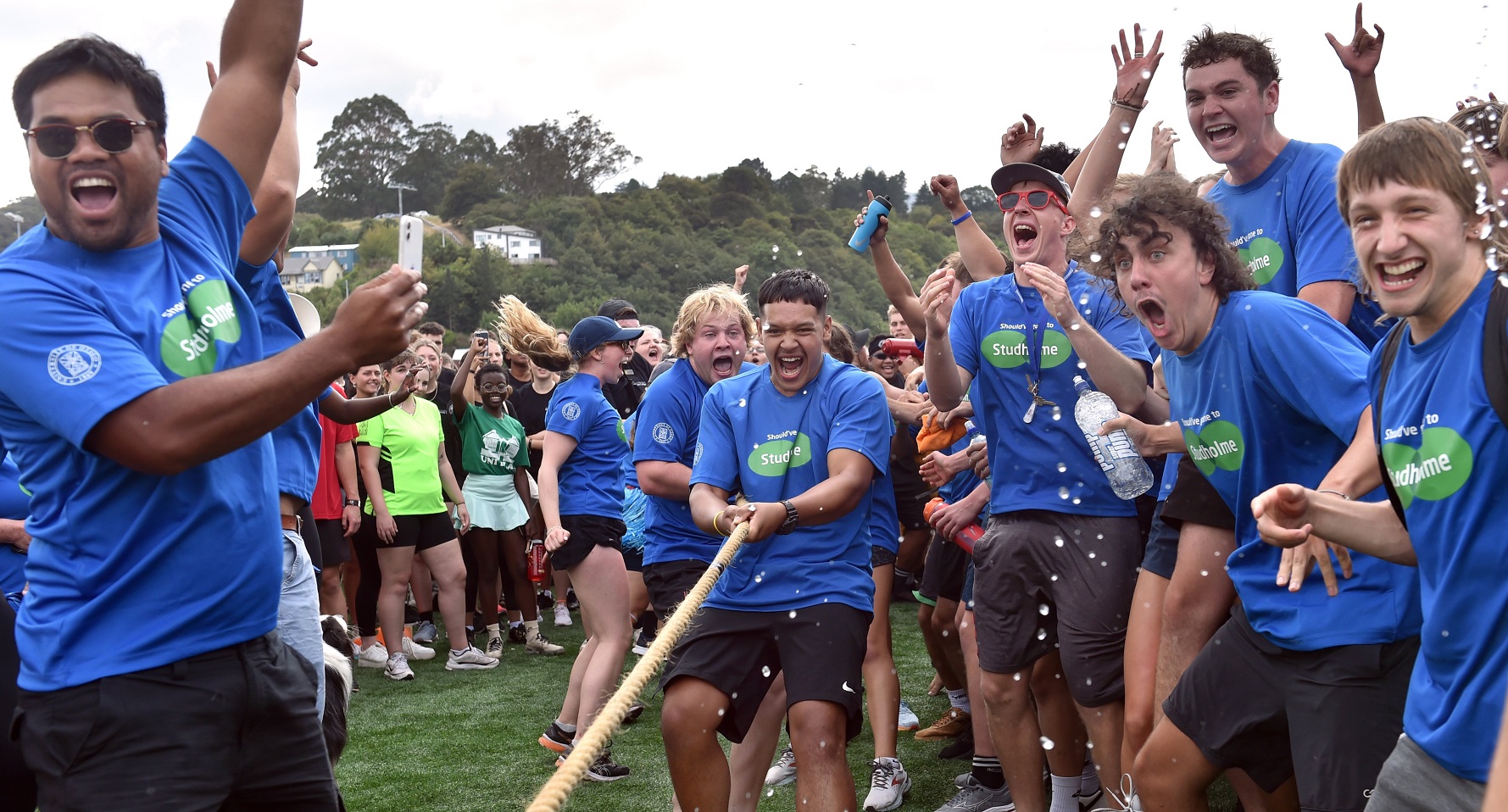 Studholme College residents celebrate as they win the tug-of-war competition final against...