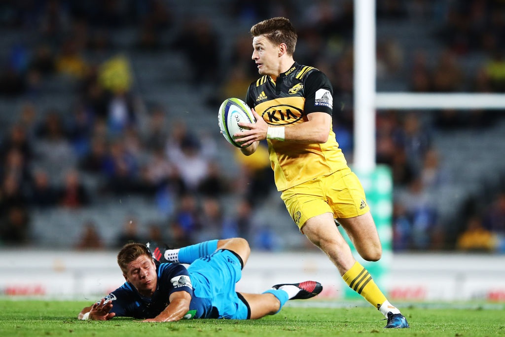 Hurricanes first five-eighth Beauden Barrett beats his Blues opposite Piers Francis during the...