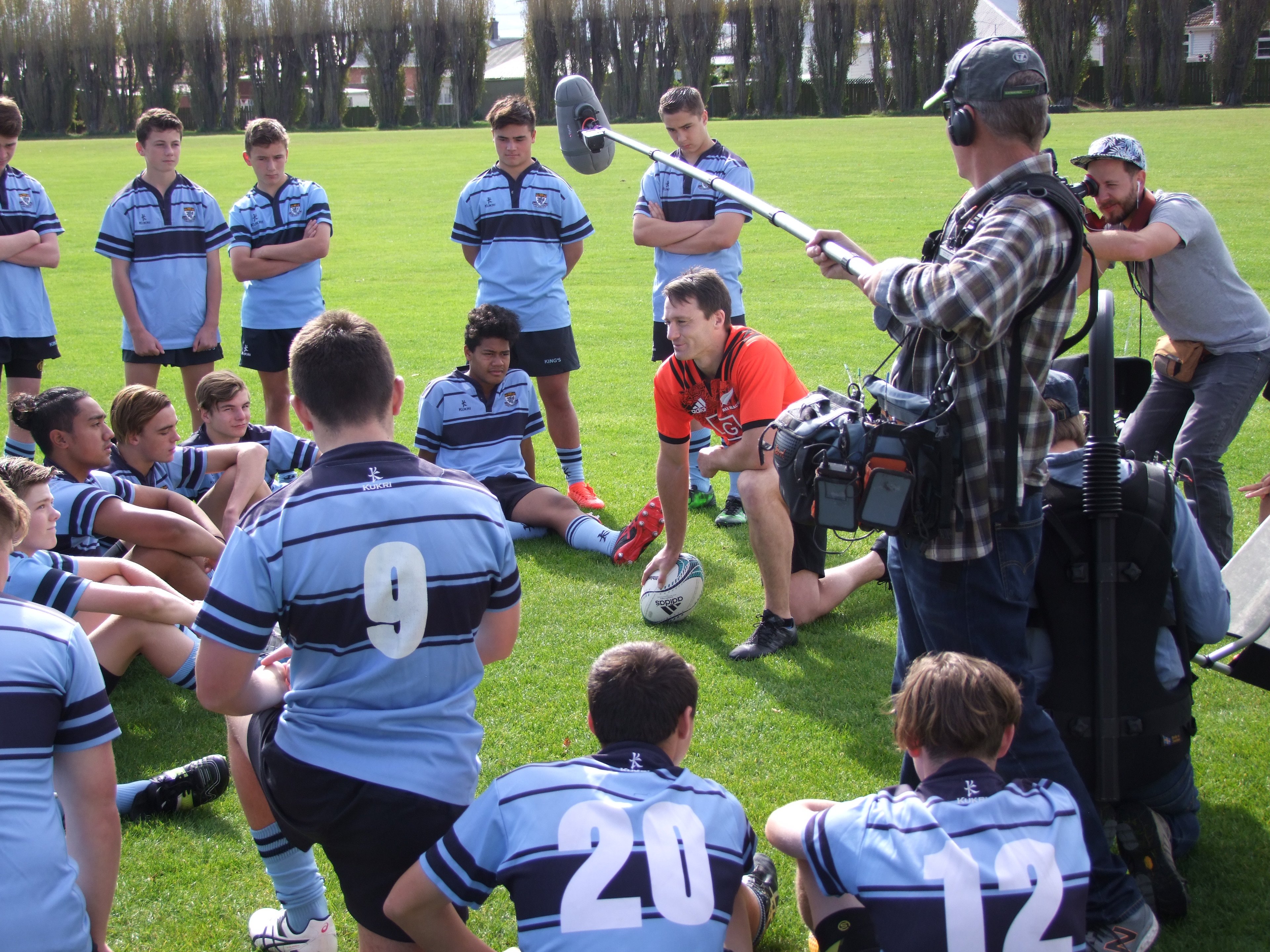 All Black fullback Ben Smith  meets the King’s rugby players on set at a Voltaren advertisement...