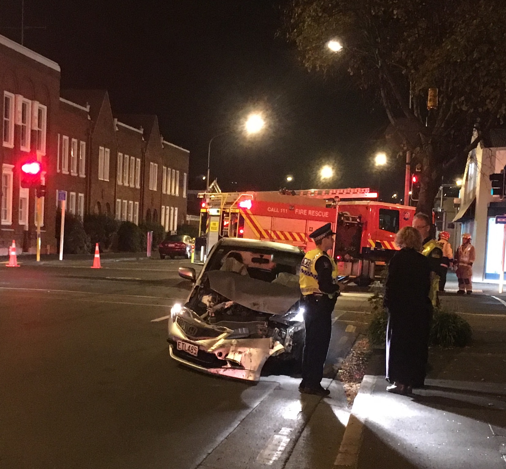 A motorist speaks to police and St John staff after the crash. Photo Shawn McAviinue 