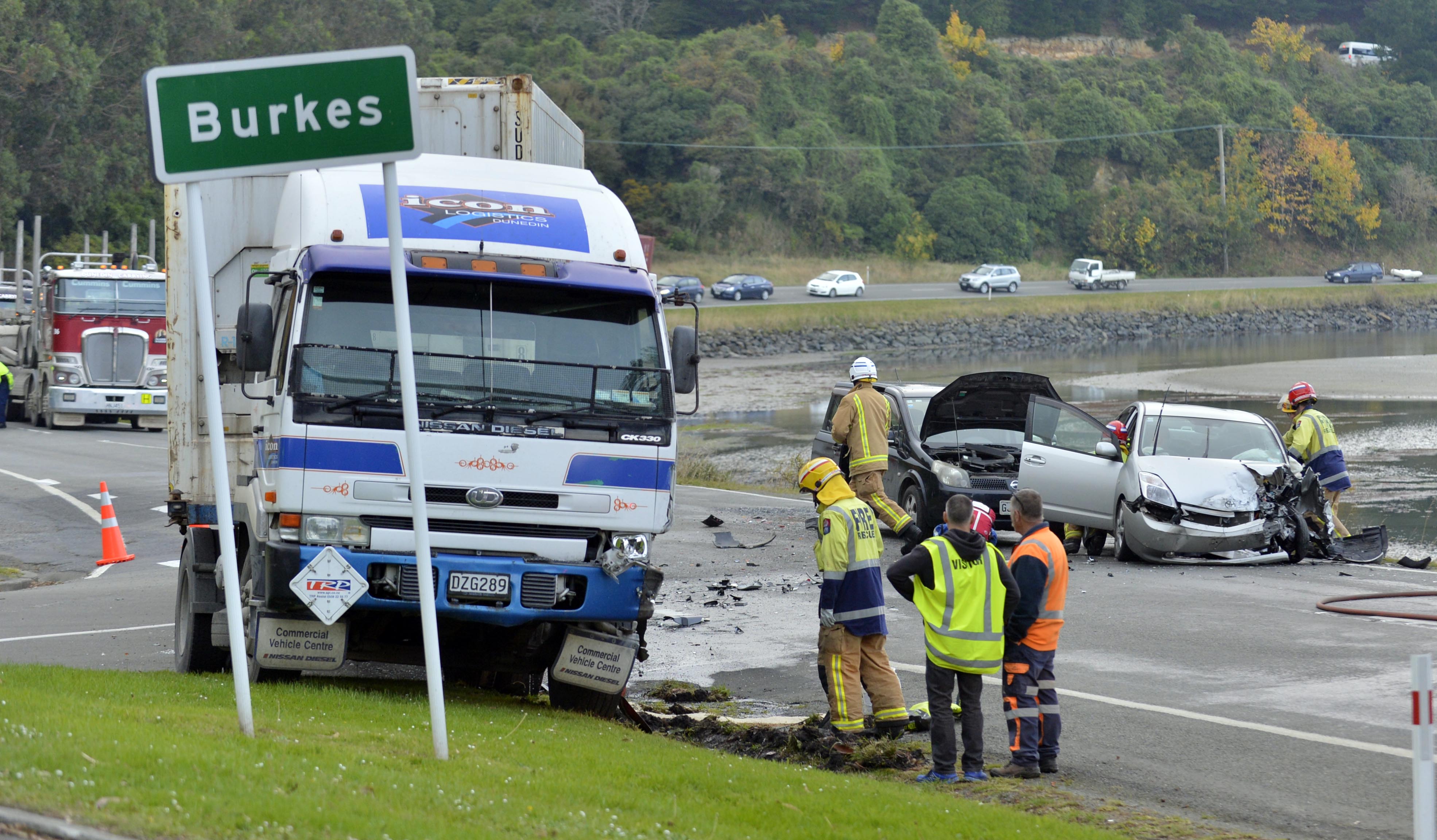 Emergency services assess the damage to a truck and car which collided at Burkes on State Highway 88 yesterday. Photo: Gerard O'Brien.