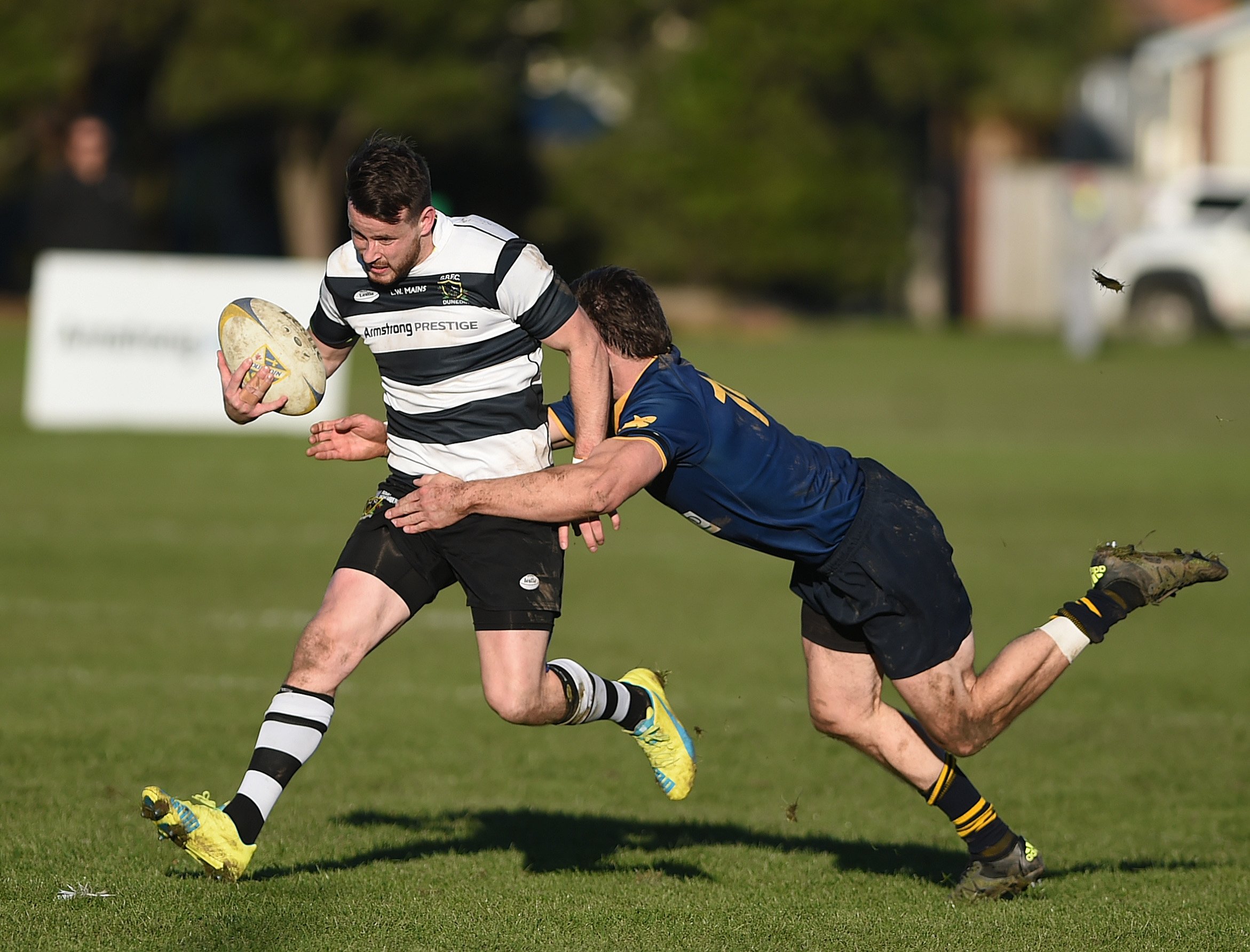 Dunedin winger Guy Woodhouse tackles Southern fullback Bryce Hosie during their game at Bathgate...