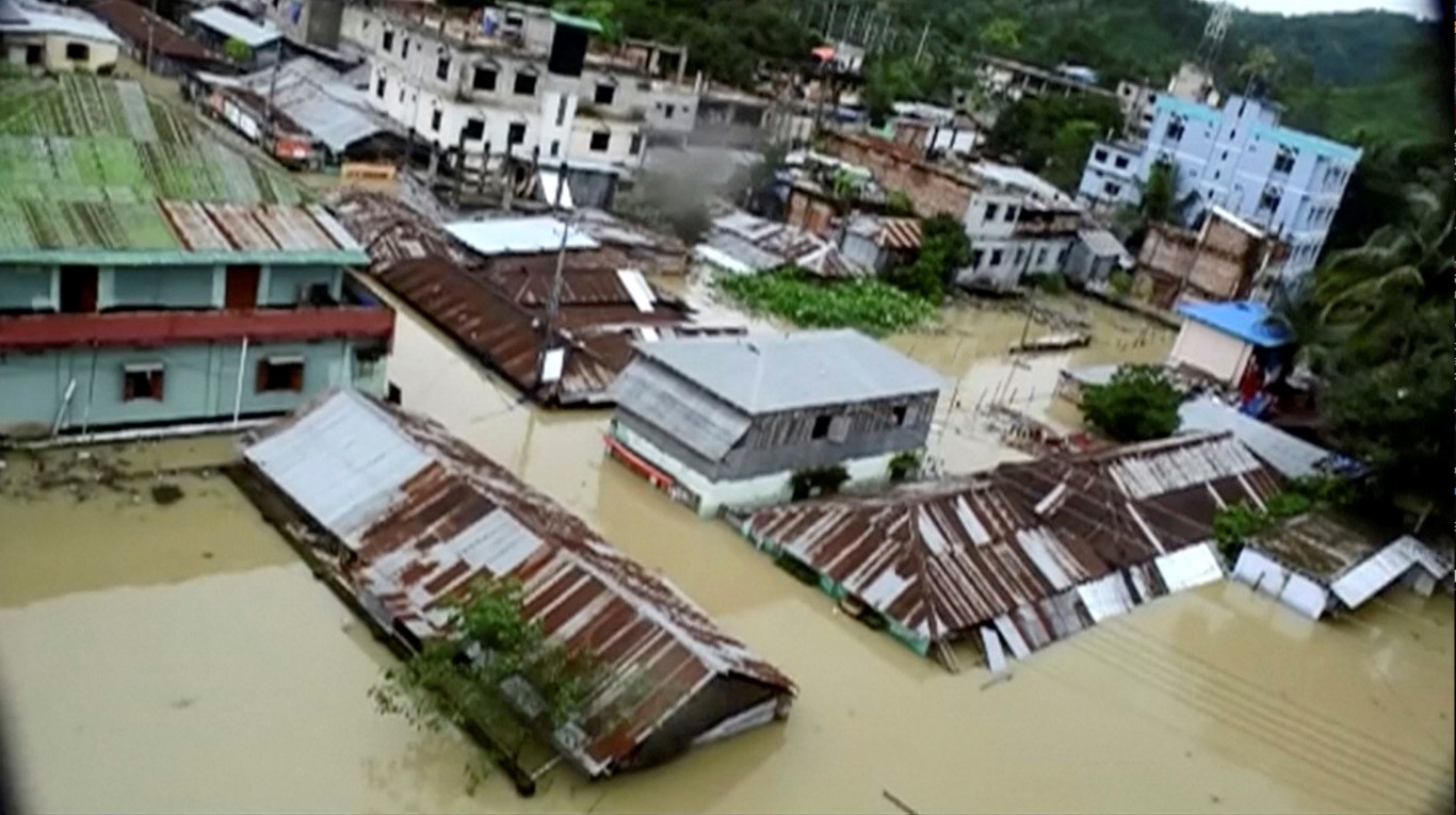 An aerial view showing the town of Khagrachari half-submerged in floodwaters following landslides...