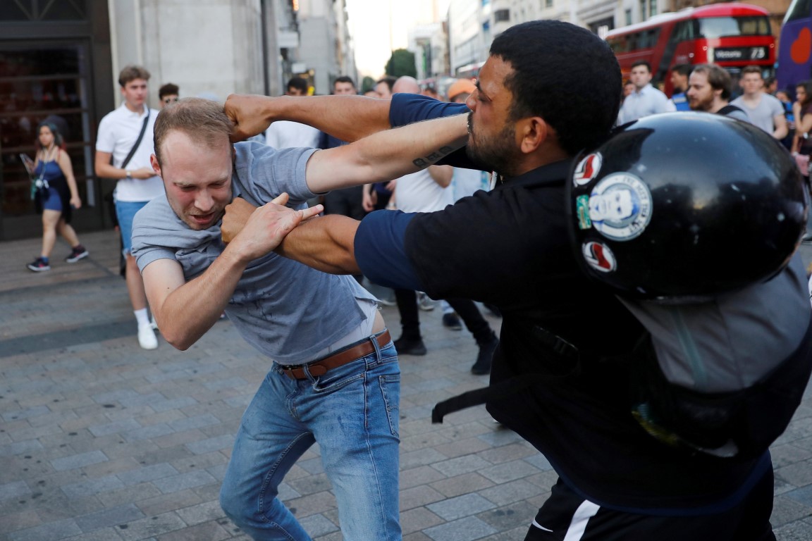 Protesters scuffle during a march in the West End following the fire. Photo Reuters