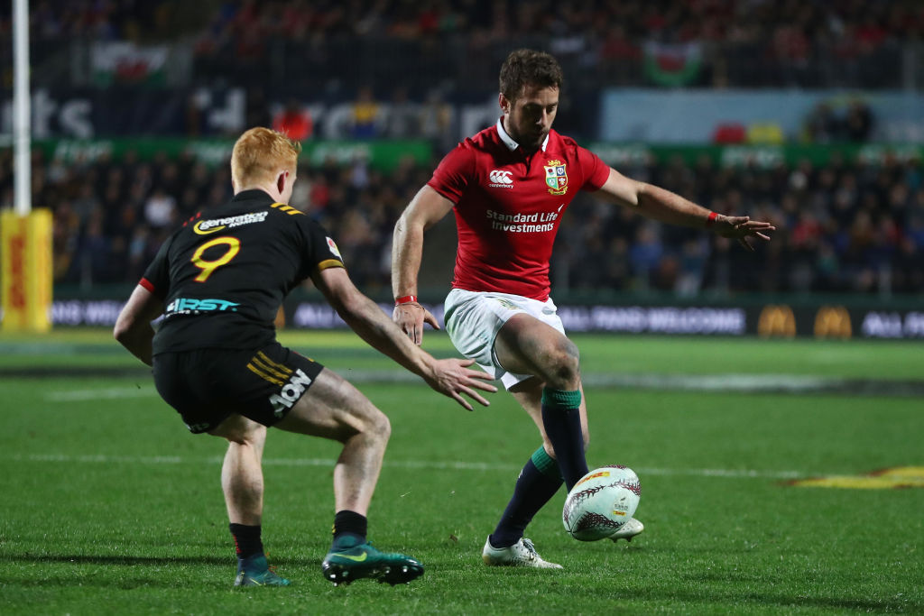 Greig Laidlaw of the Lions kicks downfield as Finlay Christie of the Chiefs closes in. Photo: Getty